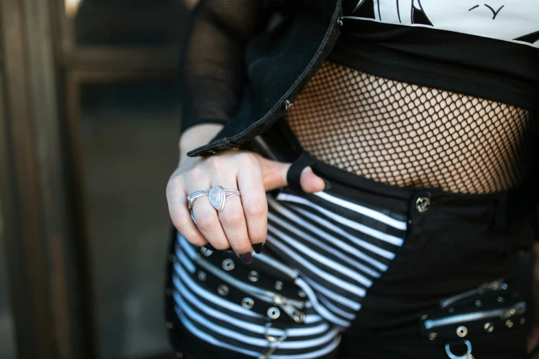 a woman's hand with a ring on her thumb