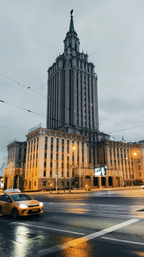 traffic travels by an old building with the dome on top