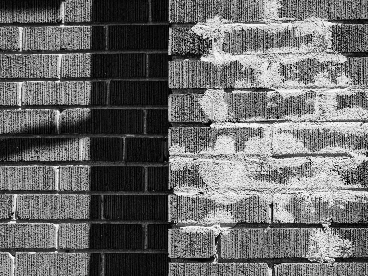 a brick wall with an abstract black and white picture