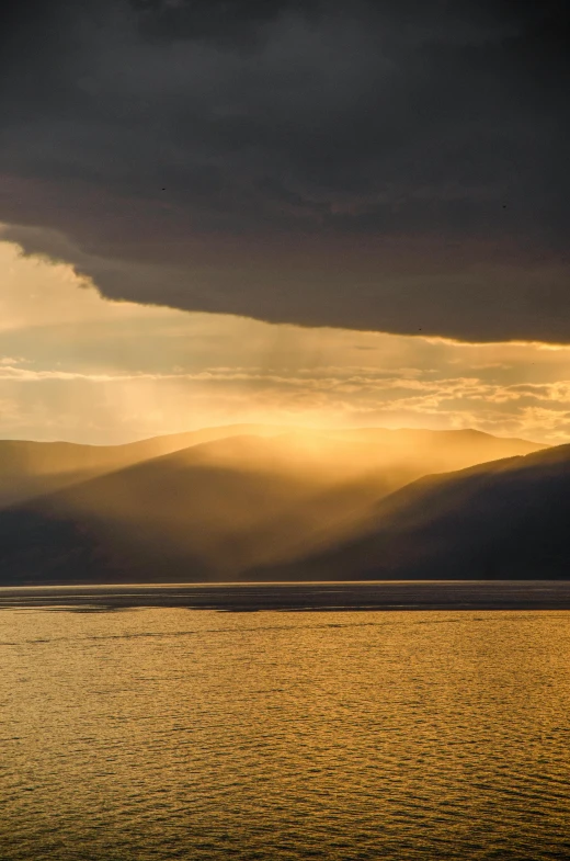 some water clouds and mountains on the horizon