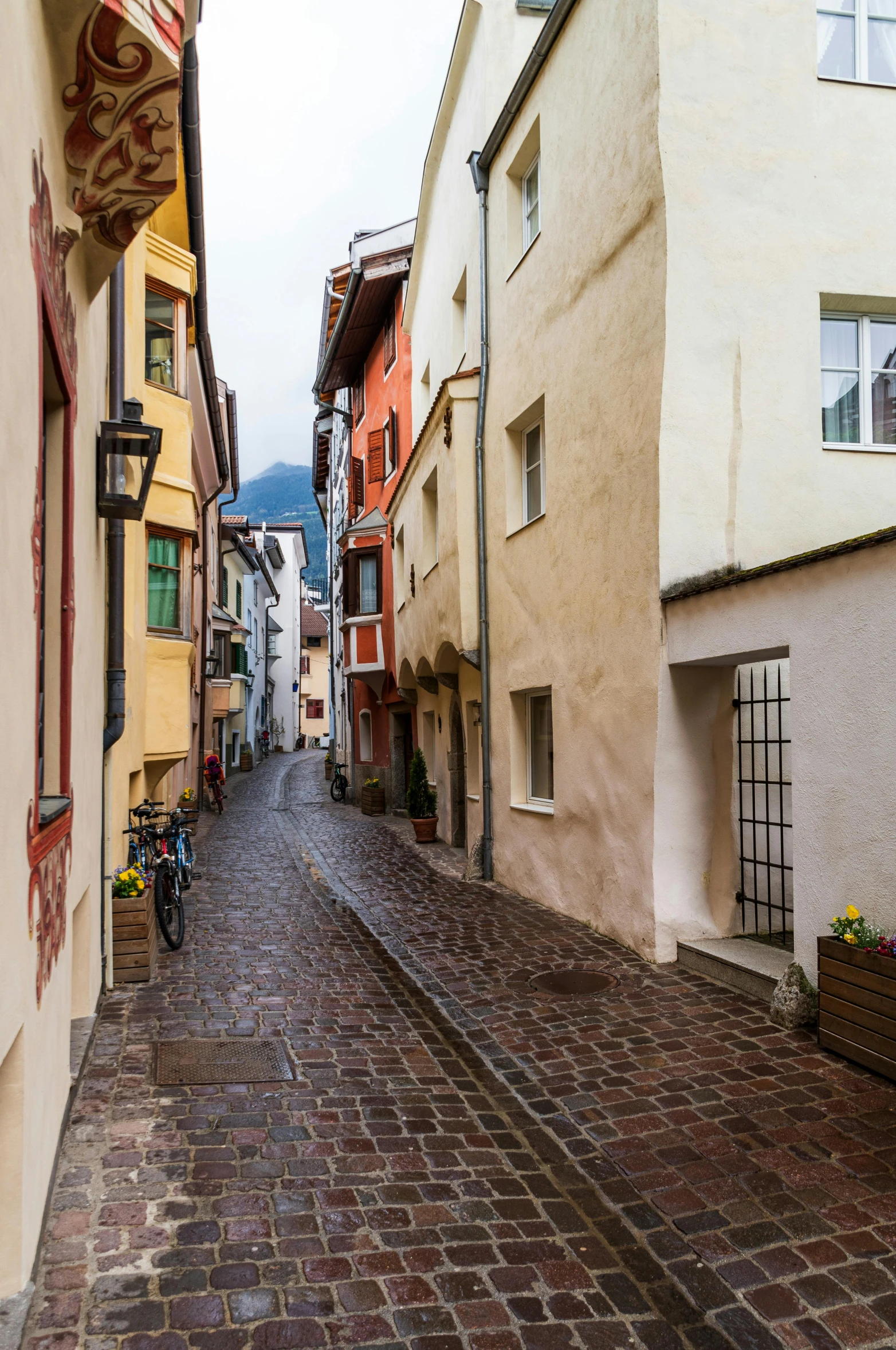 there is a very narrow street with houses all around