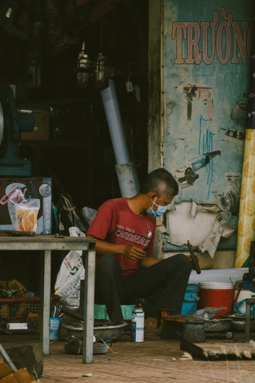 the man sitting at the table is preparing food