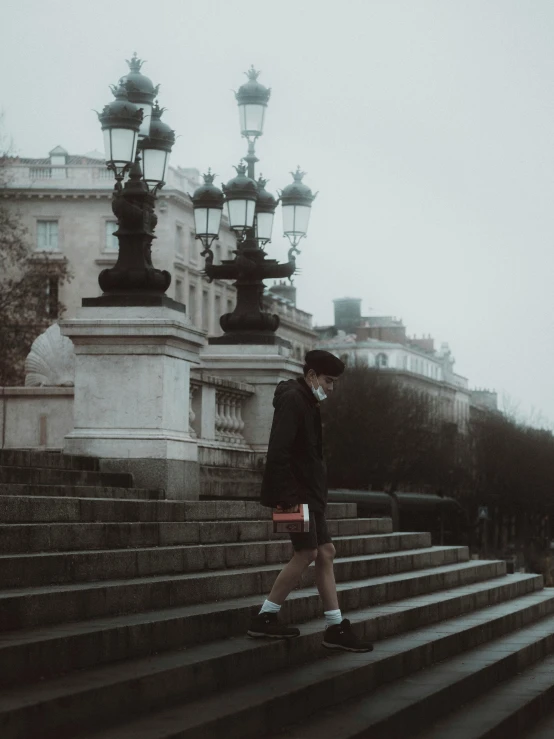 a man walking up some steps at a very old building