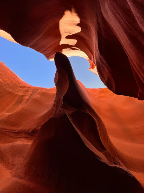 a rock arch is carved into the desert by sand