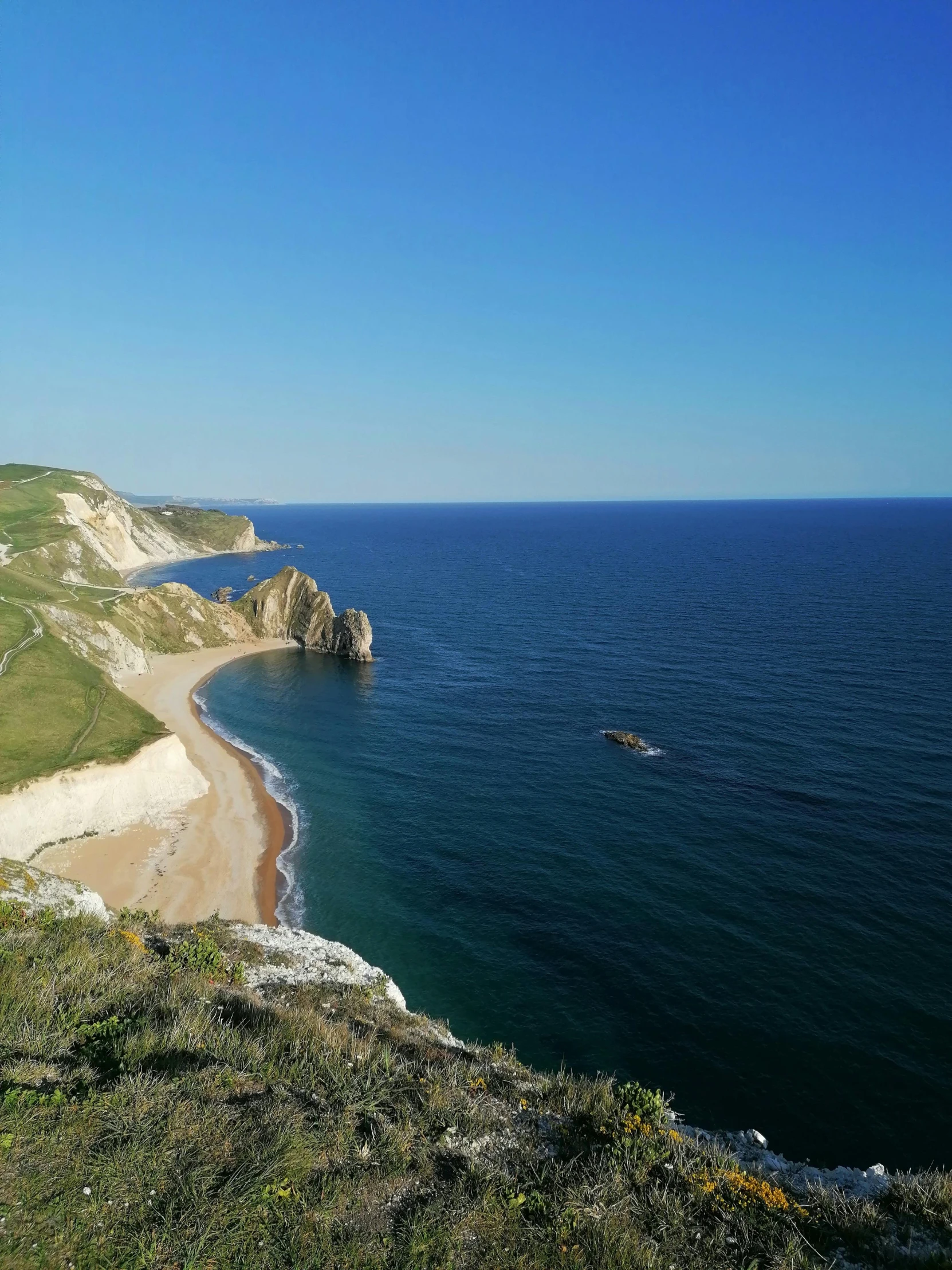 the cliffs of an island are visible near the ocean