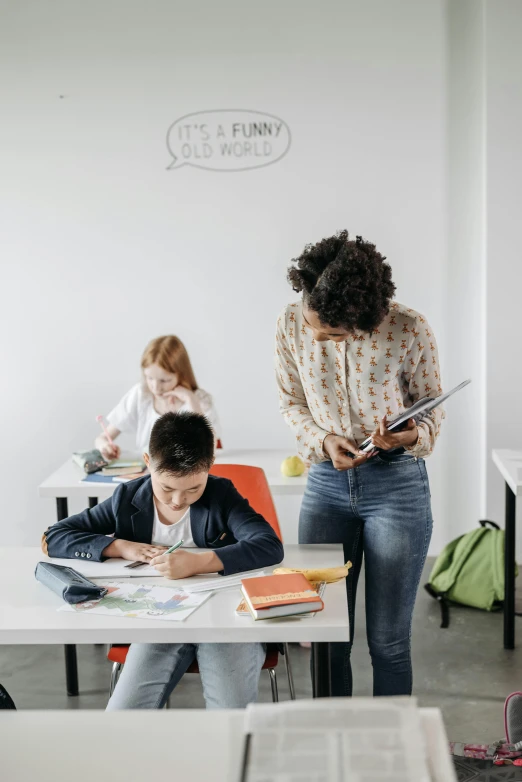 the woman is doing her homework with the children