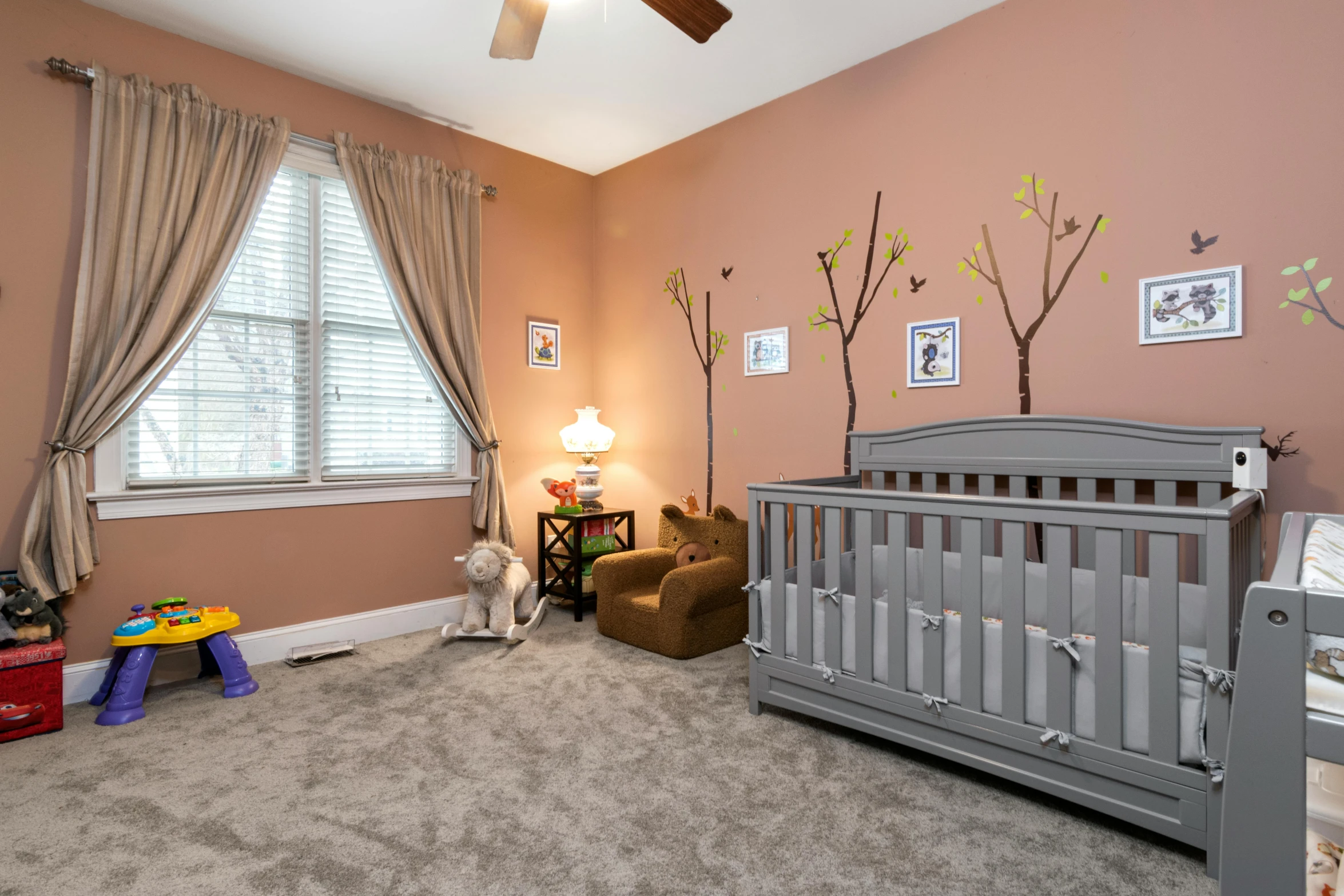 a bedroom with a baby crib and windows