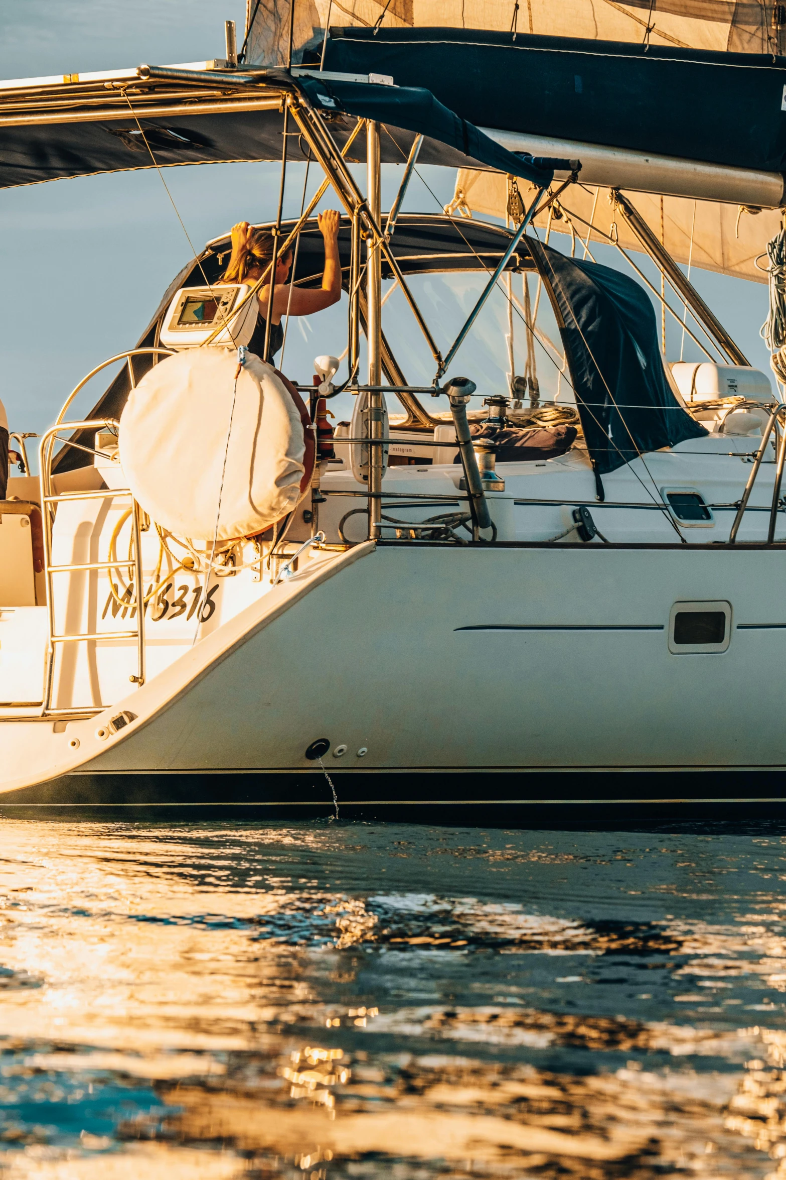 a white sailboat floats in the calm waters