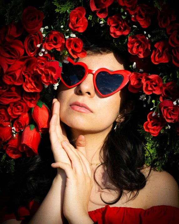 a woman with sunglasses and a rose wreath on her head