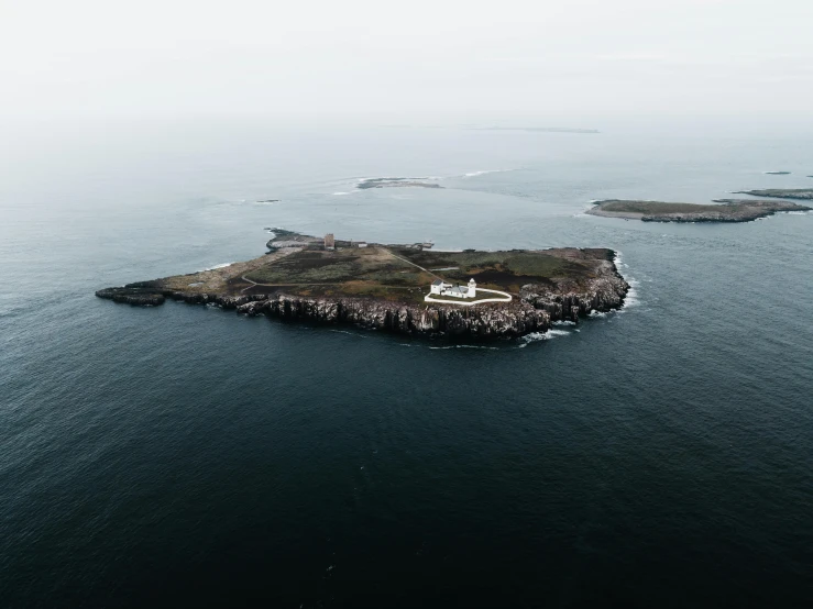 a small island sitting in the middle of some water