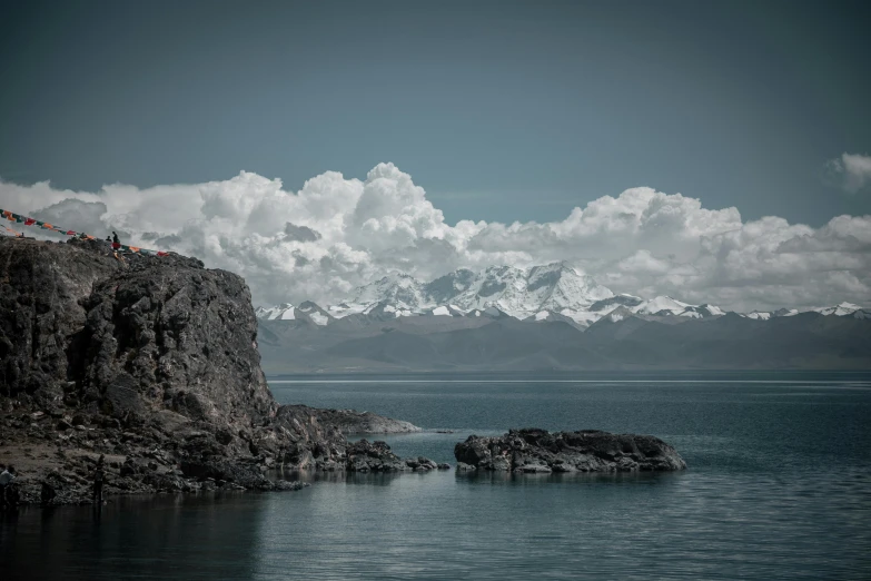 a lake and mountain range are seen in this black and white po