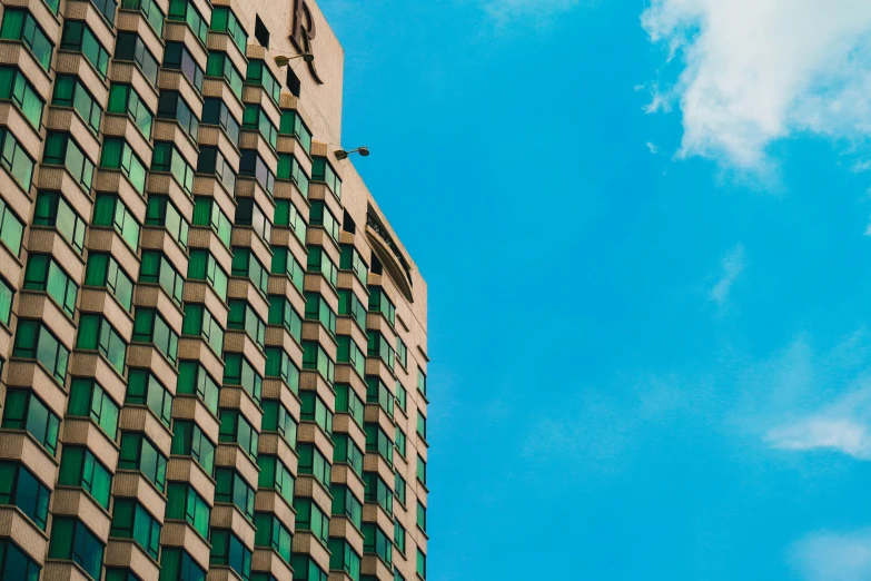 a airplane flying over a colorful building under a blue sky