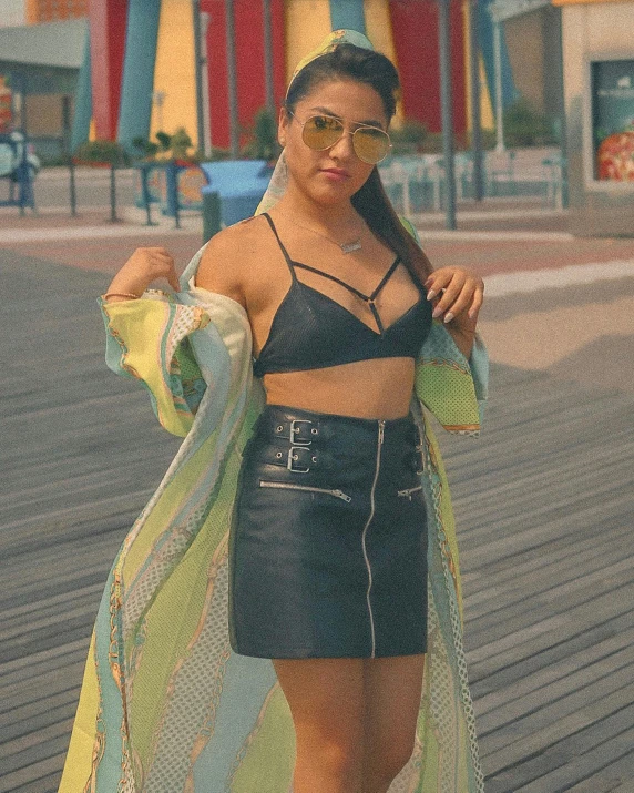 a woman standing next to a building wearing a black and white outfit