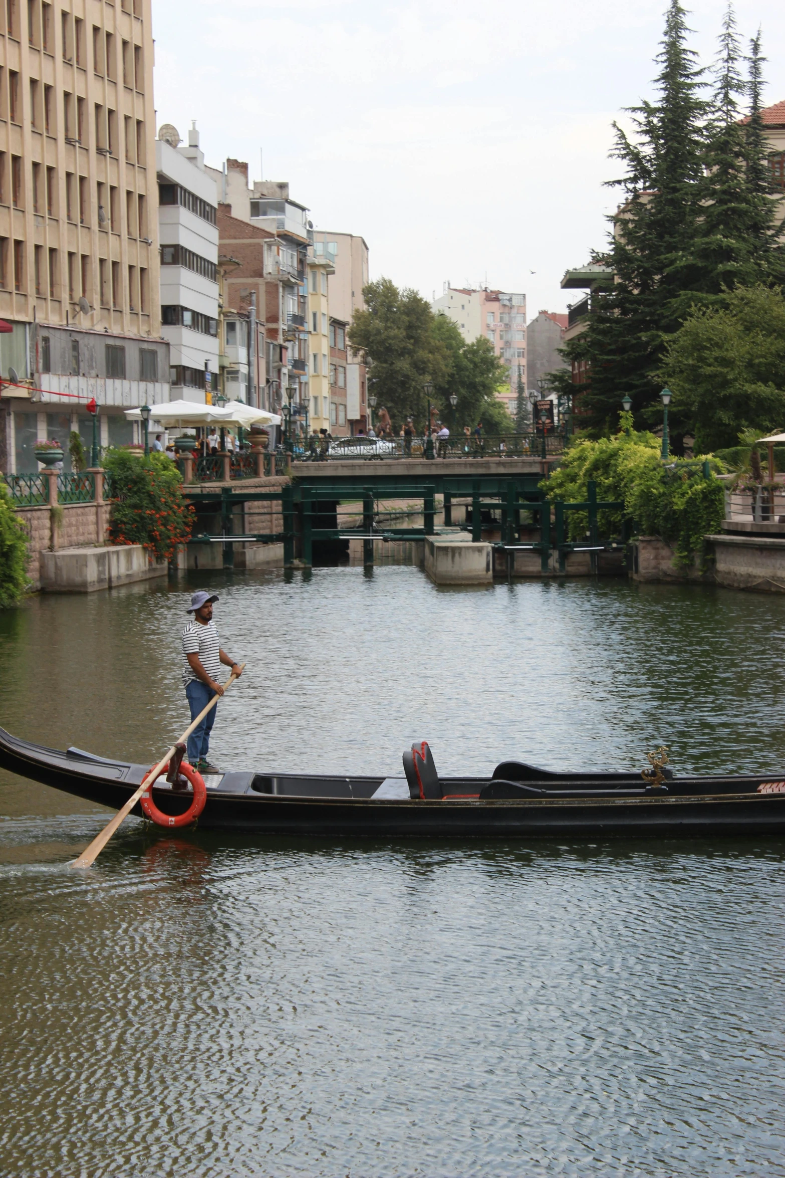 a boat on the water near some buildings and people