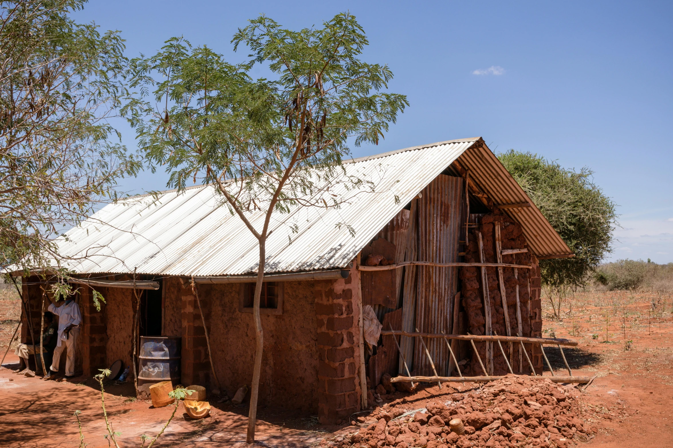 a shack with wood trim and a bare roof