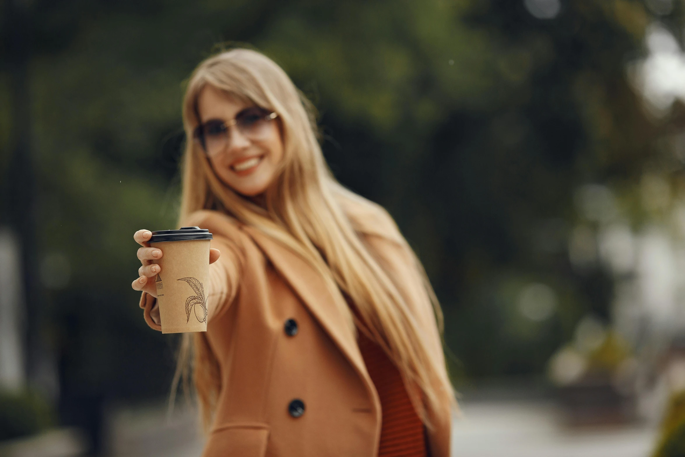 a woman is smiling and holding onto a cup of coffee