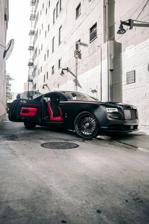 two exotic cars parked in a very dark alley