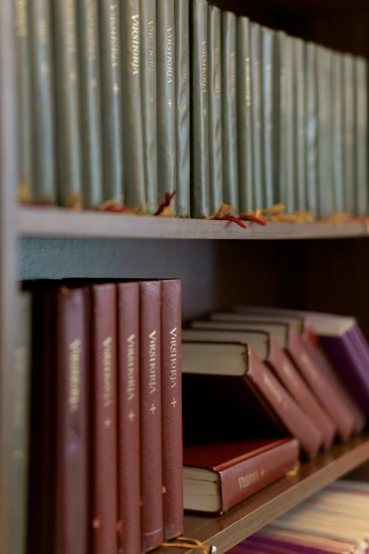 close up of book shelf displaying many books