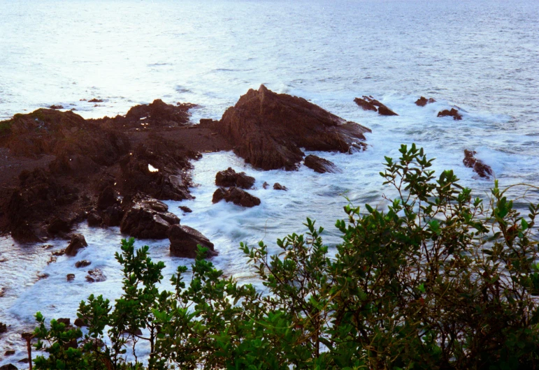 a beach area with rocks and water