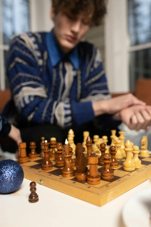 a chess game is being played with one player looking at the board
