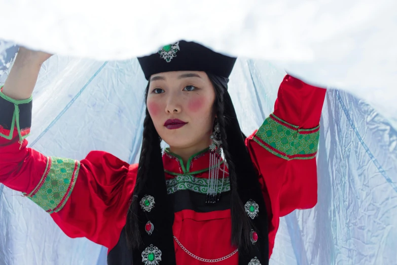 a woman dressed up with lots of beads and a hat