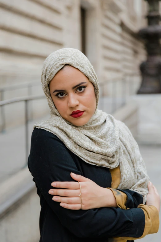 a woman with long dark hair wearing a hijab