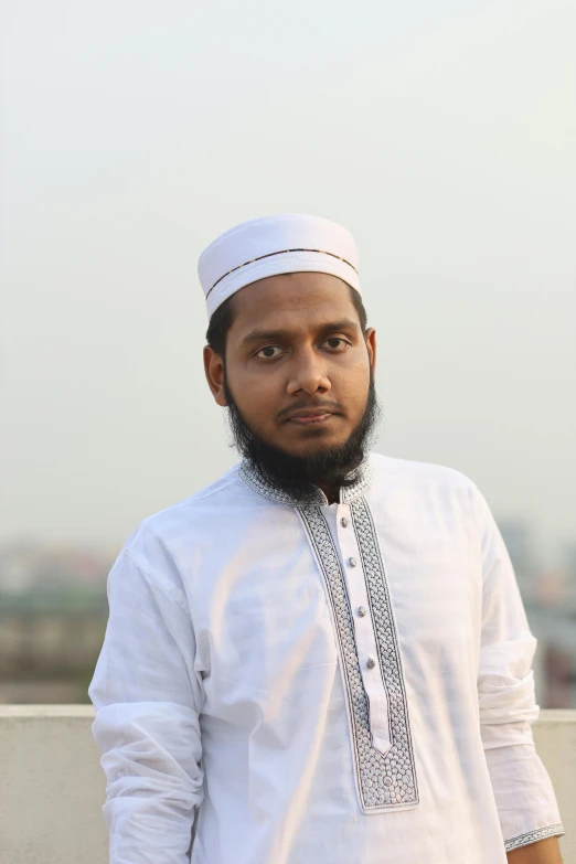 a man with a turban standing on a rooftop