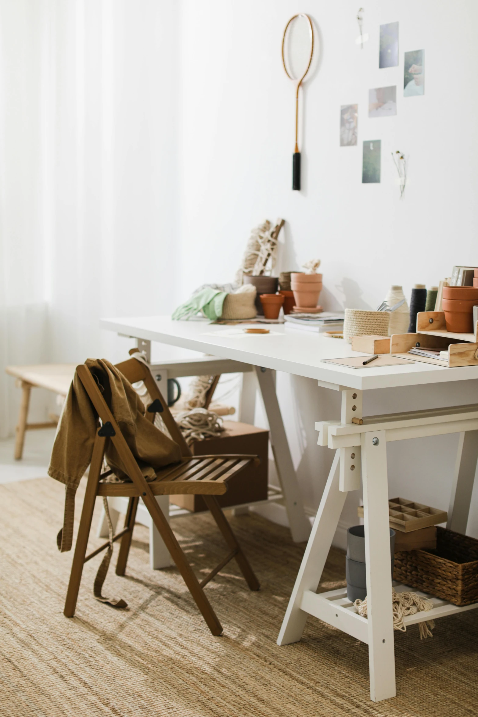 a table with a white bench sitting next to it