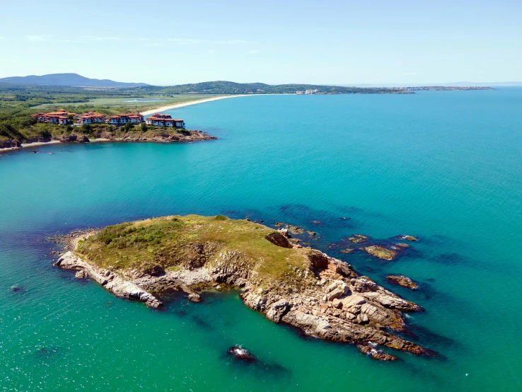 an aerial s of a beach and island surrounded by water