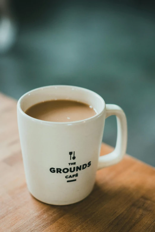 a cup of coffee on top of a wooden table