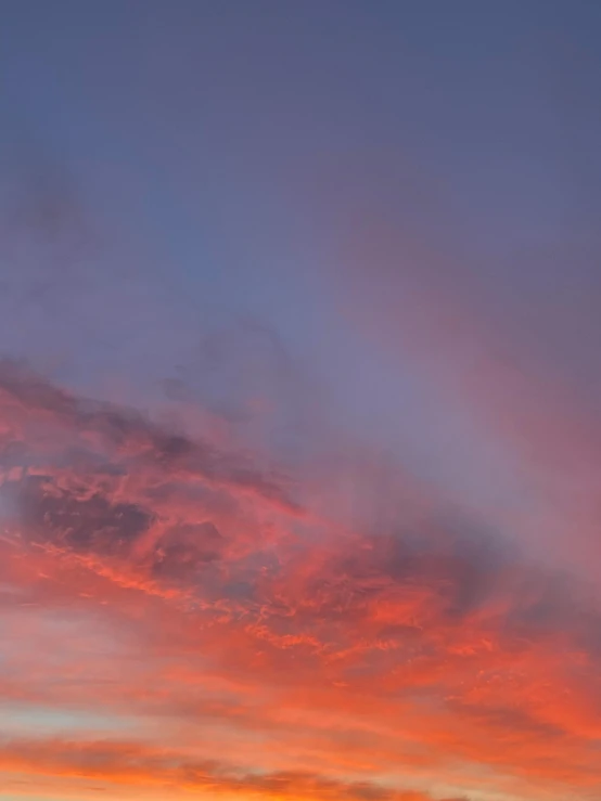 the sun setting on top of a hill