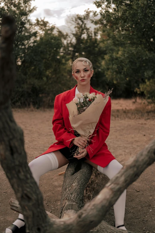 a person with white shoes sitting on a tree stump