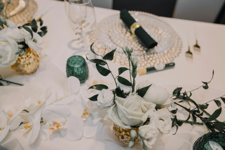 white flowers are displayed in tiny vases on a table