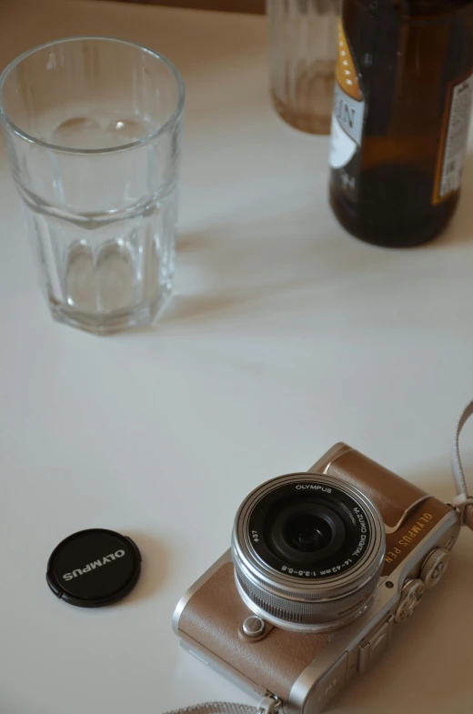 a camera and some glass on a table