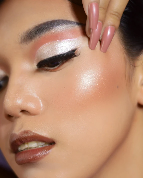 a beautiful woman wearing pink and white eye shadow makeup