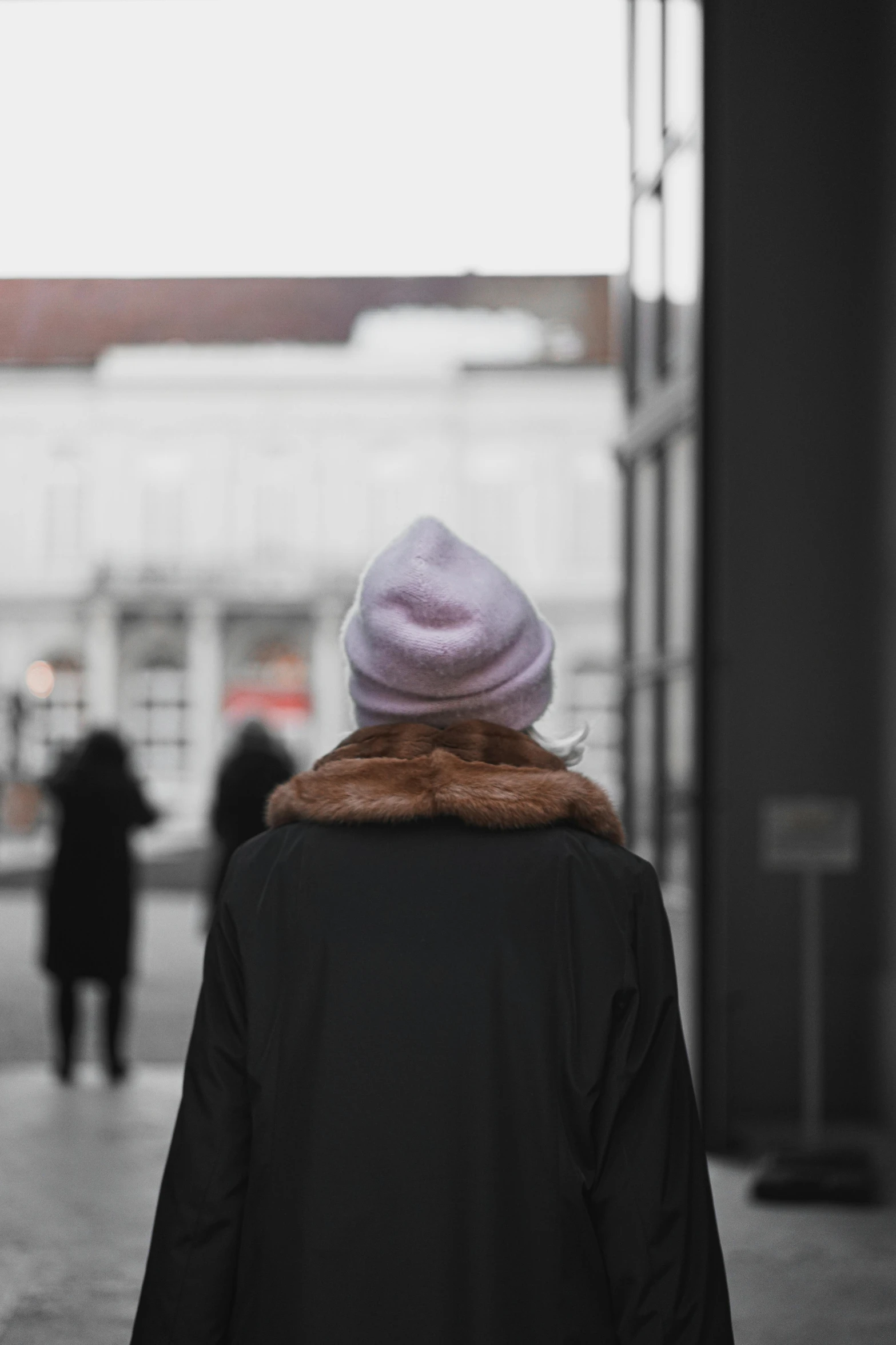 a woman walking in the rain holding an umbrella