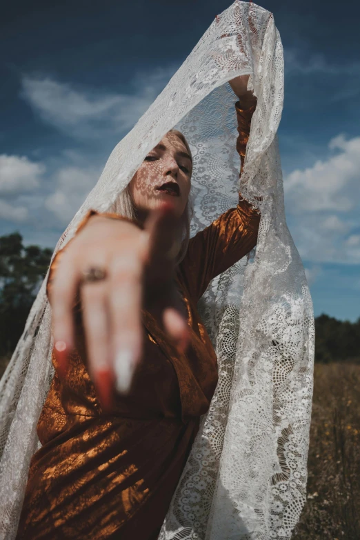 woman holding up white fabric to show if she likes the trick