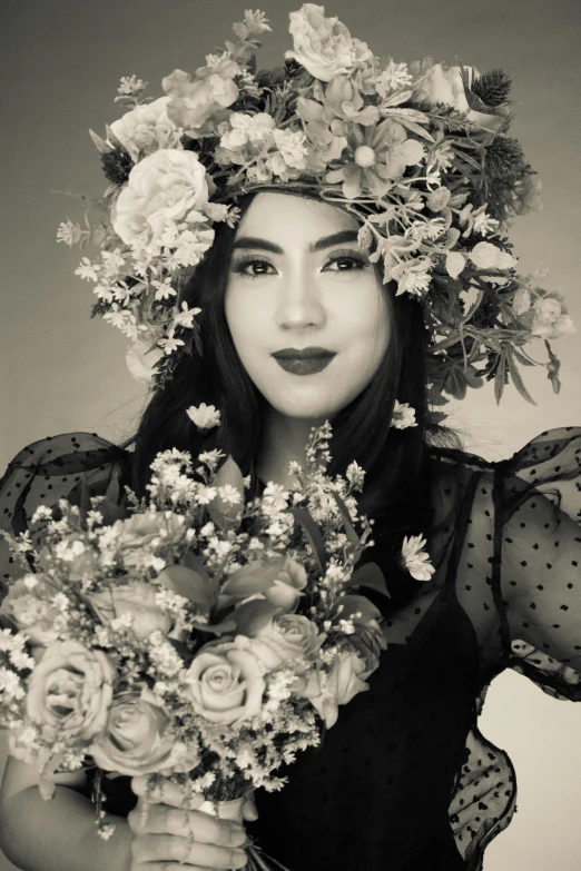 black and white po of a woman with flowers in her hair