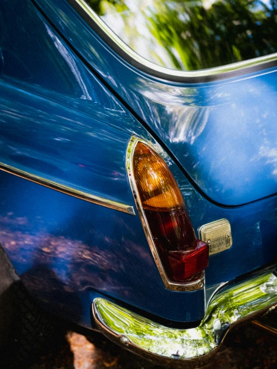 the back end of a blue vintage car