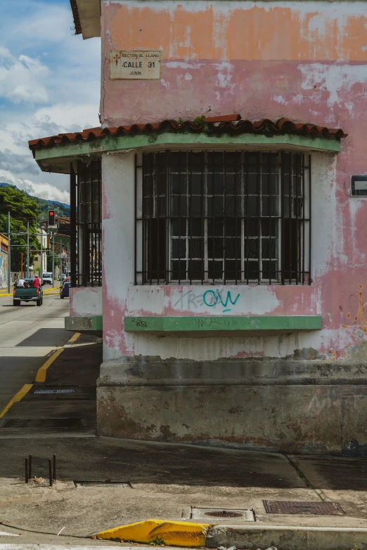 a pink and white building with a green sign that says eva