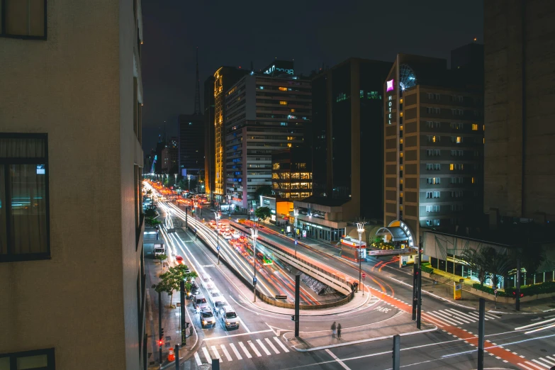 city street in city at night with buildings