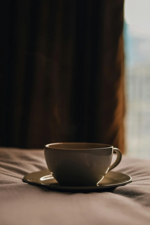 this cup sits in the middle of a plate on the bed