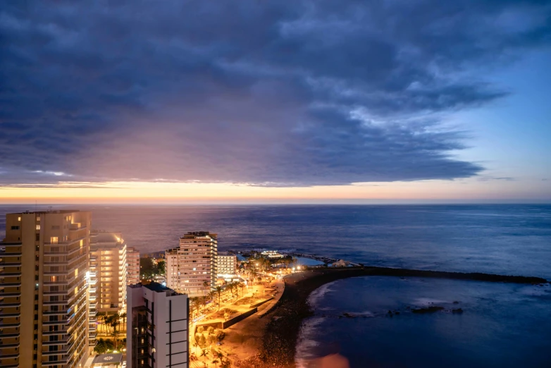 a city with a very high rise overlooking the ocean