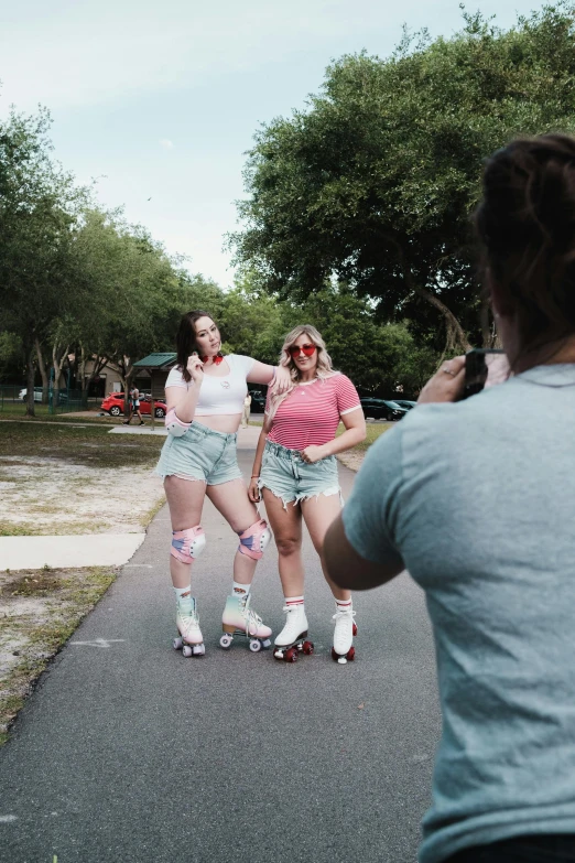 three girls in roller skates are posing together