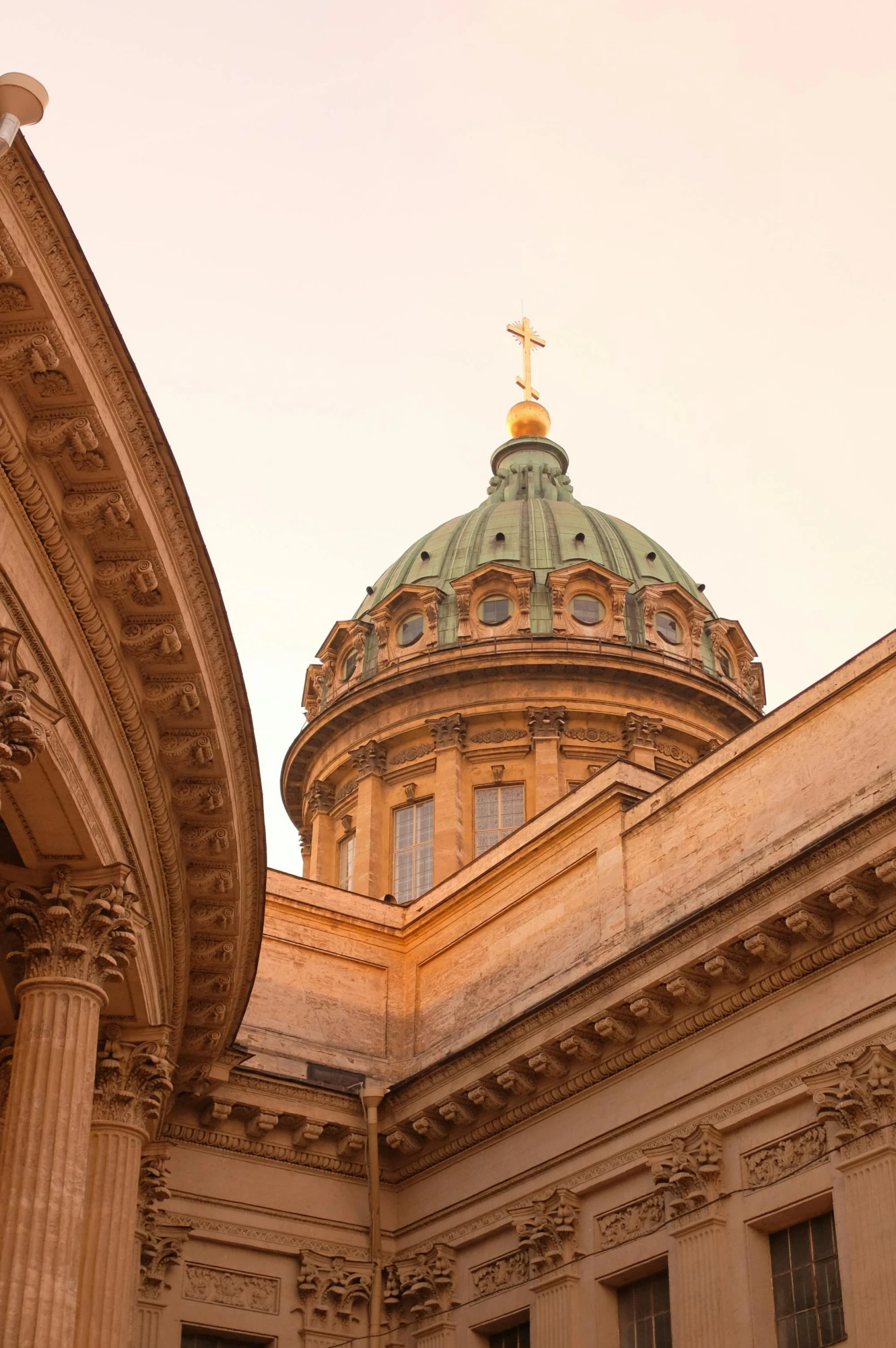 a dome with a cross atop the roof of a building