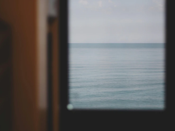 a large body of water seen through some open doors