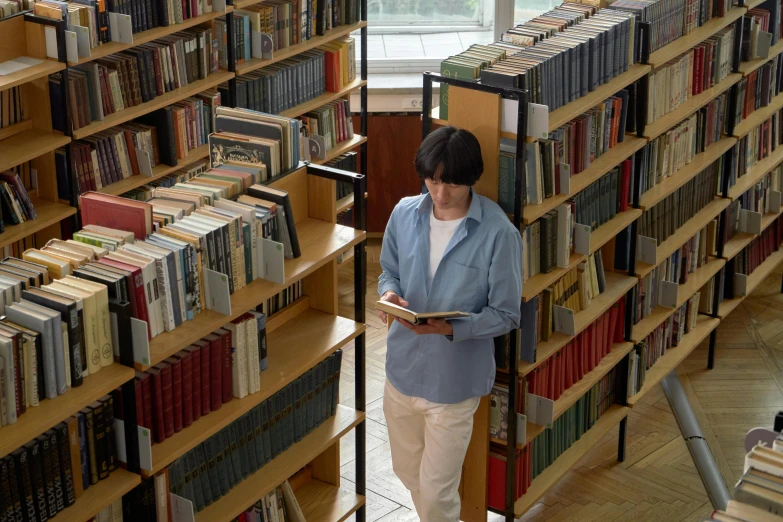 a woman reading in a liry surrounded by books