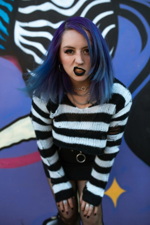 a woman with purple hair and blue wig