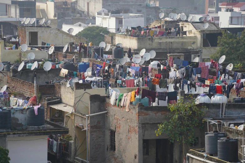 a city with a lot of buildings and clothes on lines