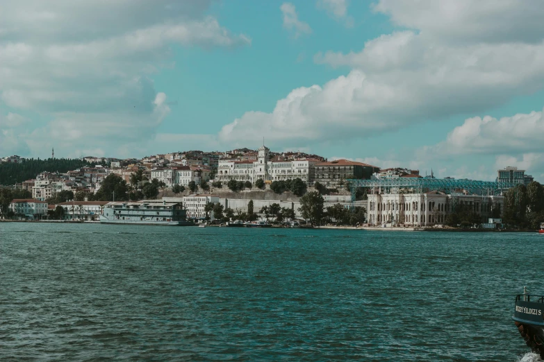 a group of white houses on a hill overlooking the water